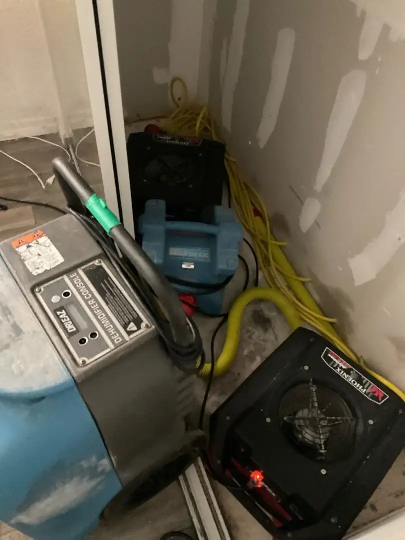 Drying equipment packed into a closet during water-damage restoration.