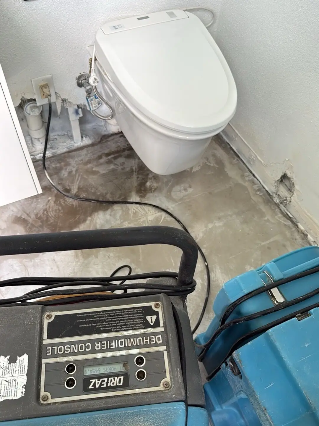 Bathroom subfloor drying after flooring removal in Little Havana.