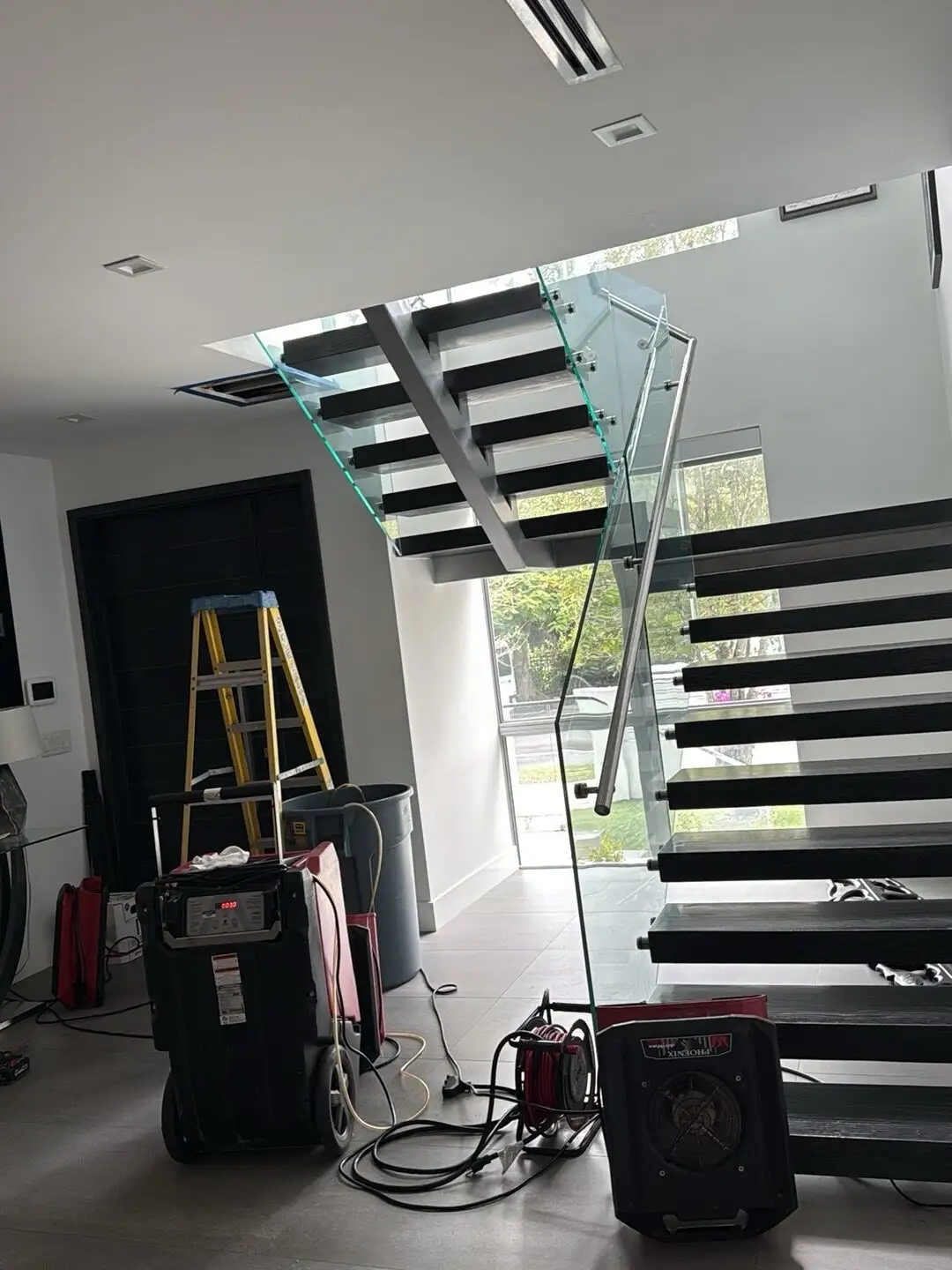 Drying equipment in a Little Havana stair hall after a ceiling leak.