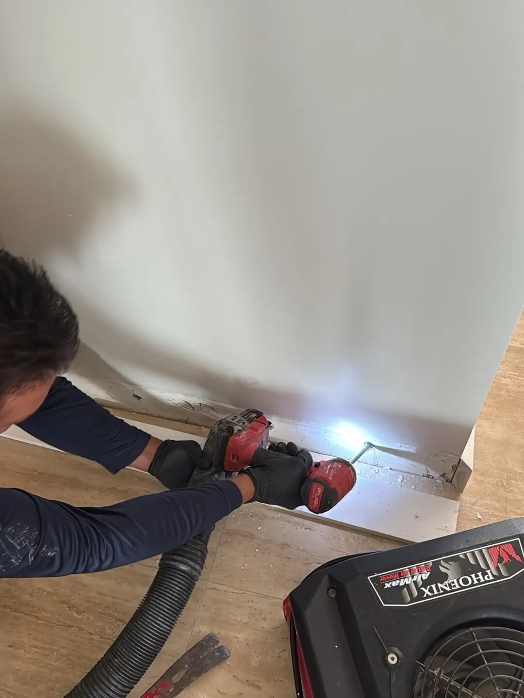 Flood-cut drywall with dust control in Miami Beach.