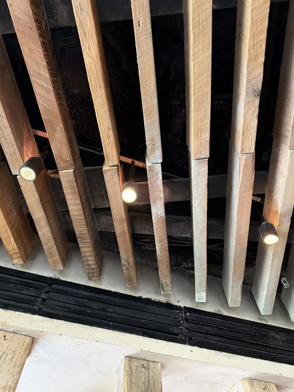 Fine sanitizing fog around rustic wood-slat ceiling beams and spotlights.