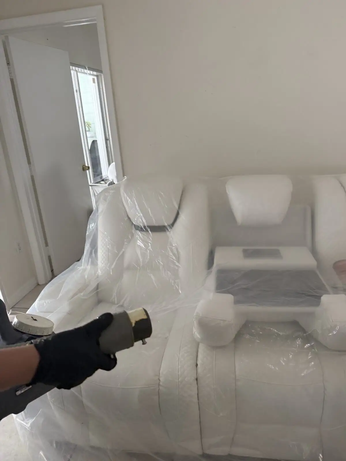 ULV fogging a covered sofa during sanitization.