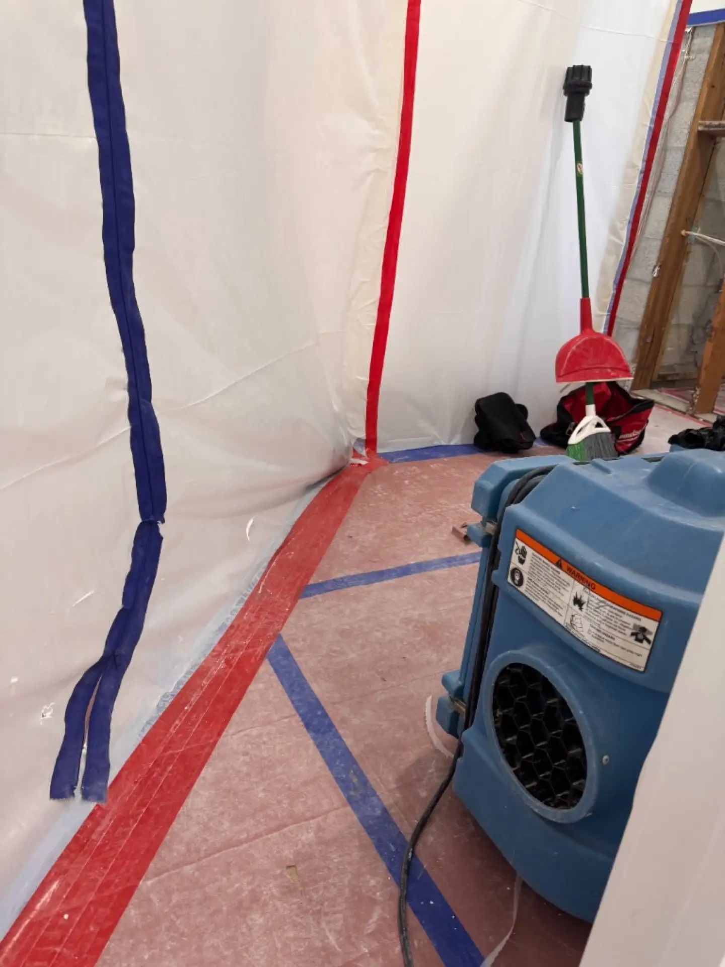 Zippered containment entry with HEPA equipment during Davie bedroom and bathroom mold remediation