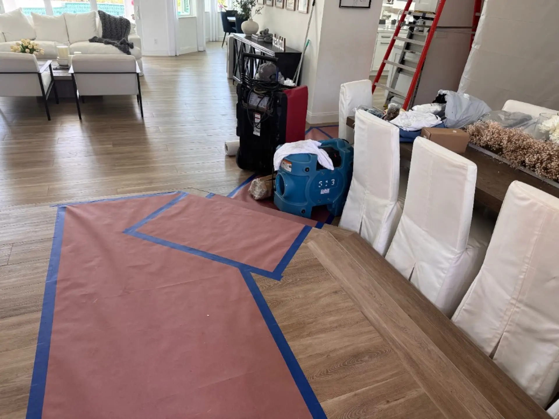 Floor protection, drying equipment, and plastic containment isolating the work area from the rest of the Davie home