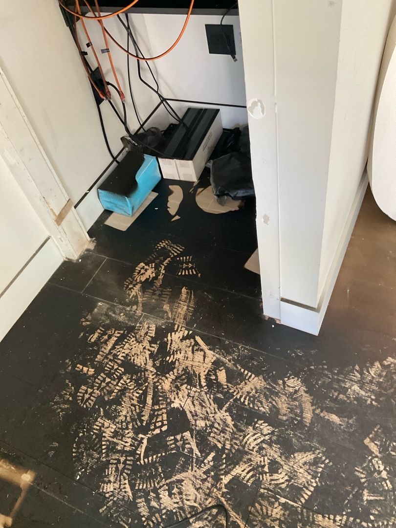 Fire damage to residential floors showing soot and burn damage