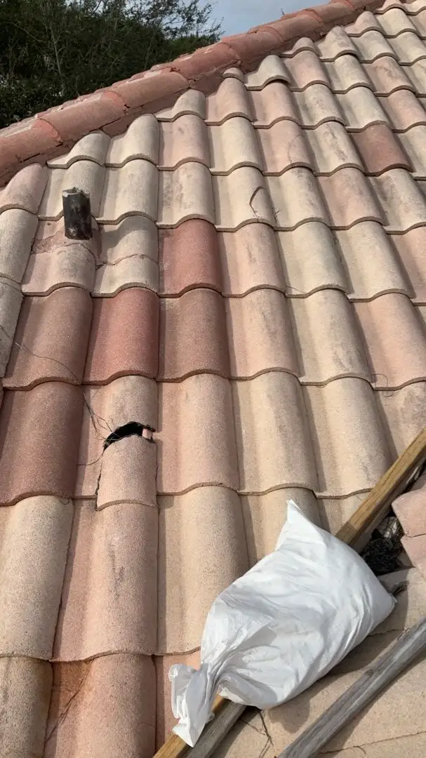 Damaged terracotta roof tiles from storm or hurricane impact