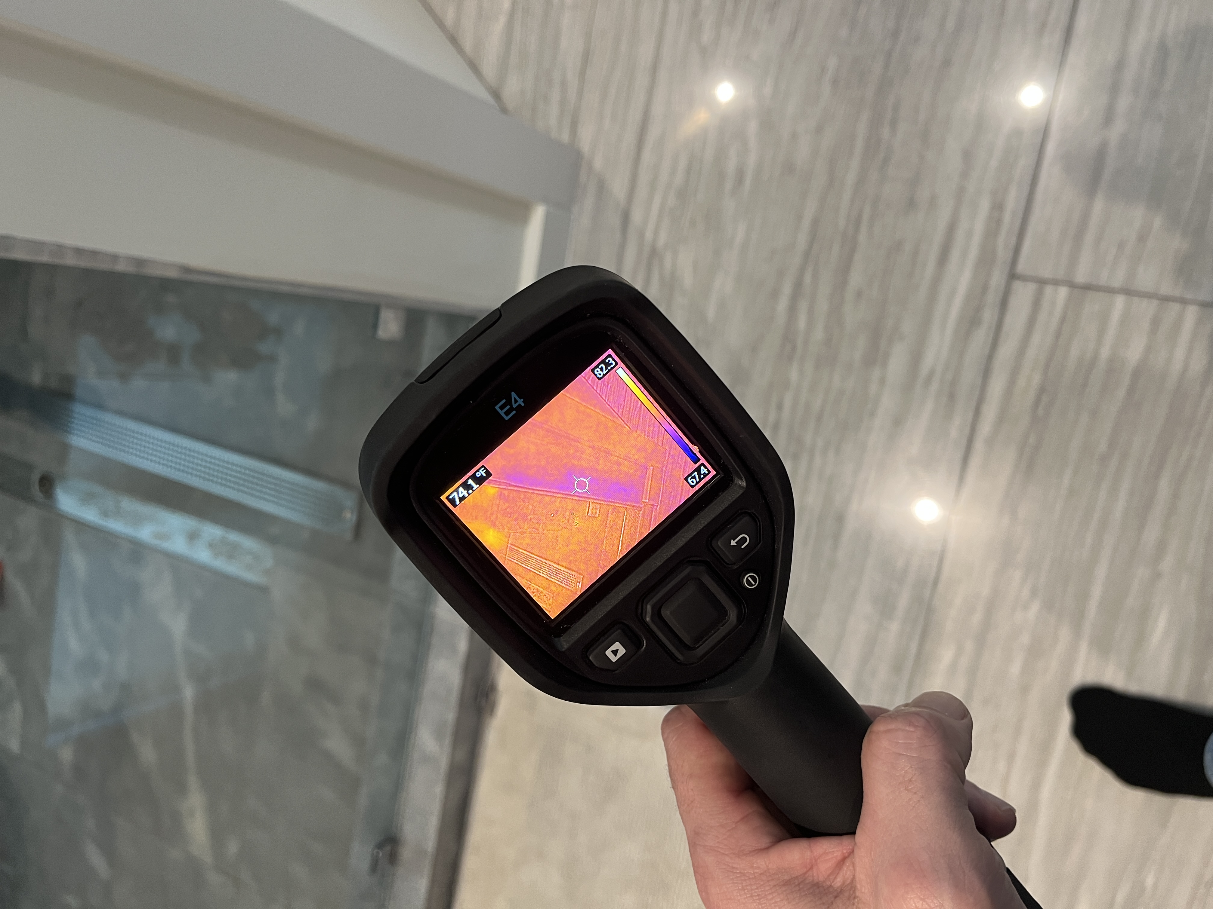 Professional checking for water damage in bathroom during restoration inspection