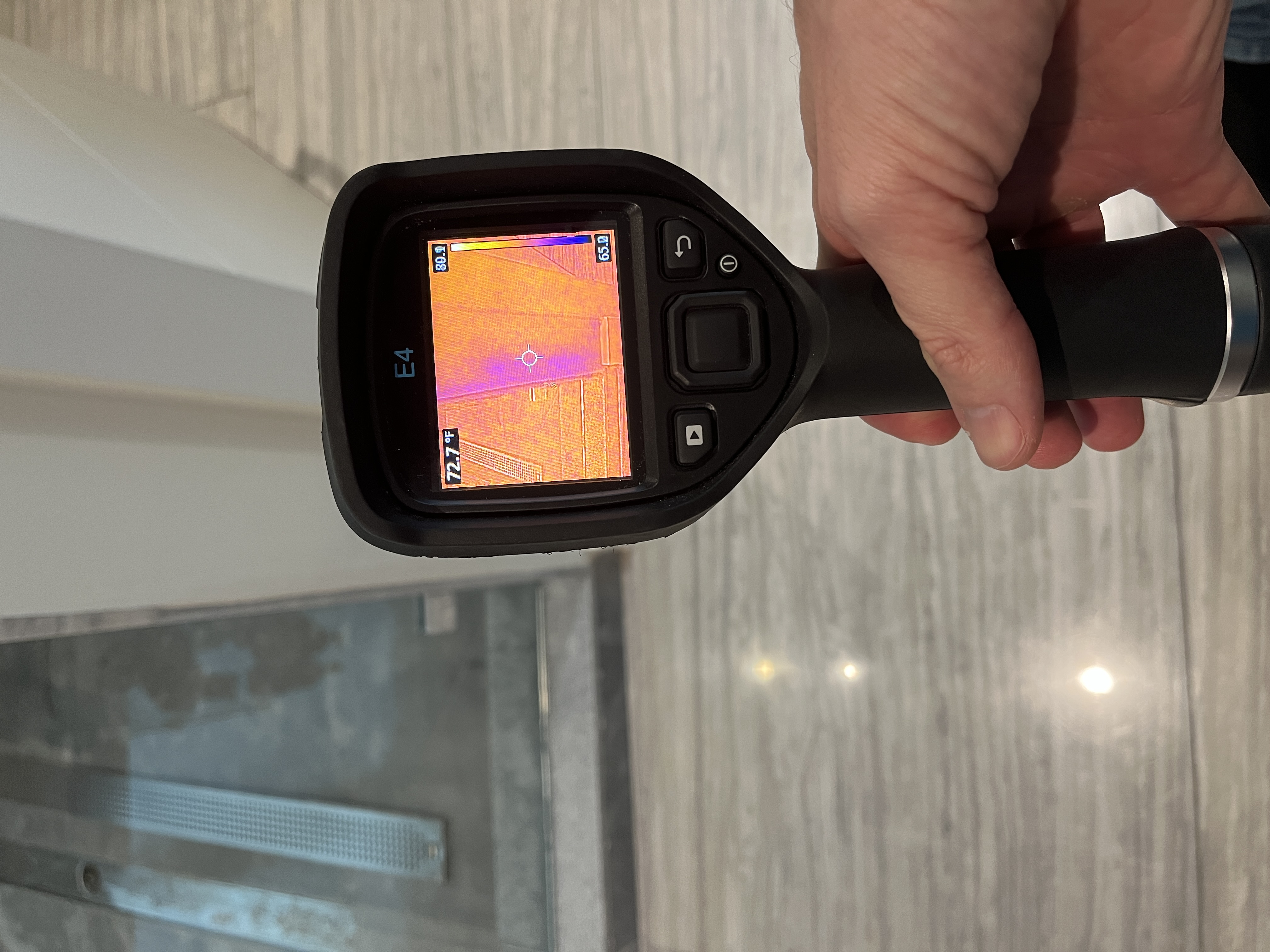 Professional moisture detection with flair gun in bathroom for water damage assessment
