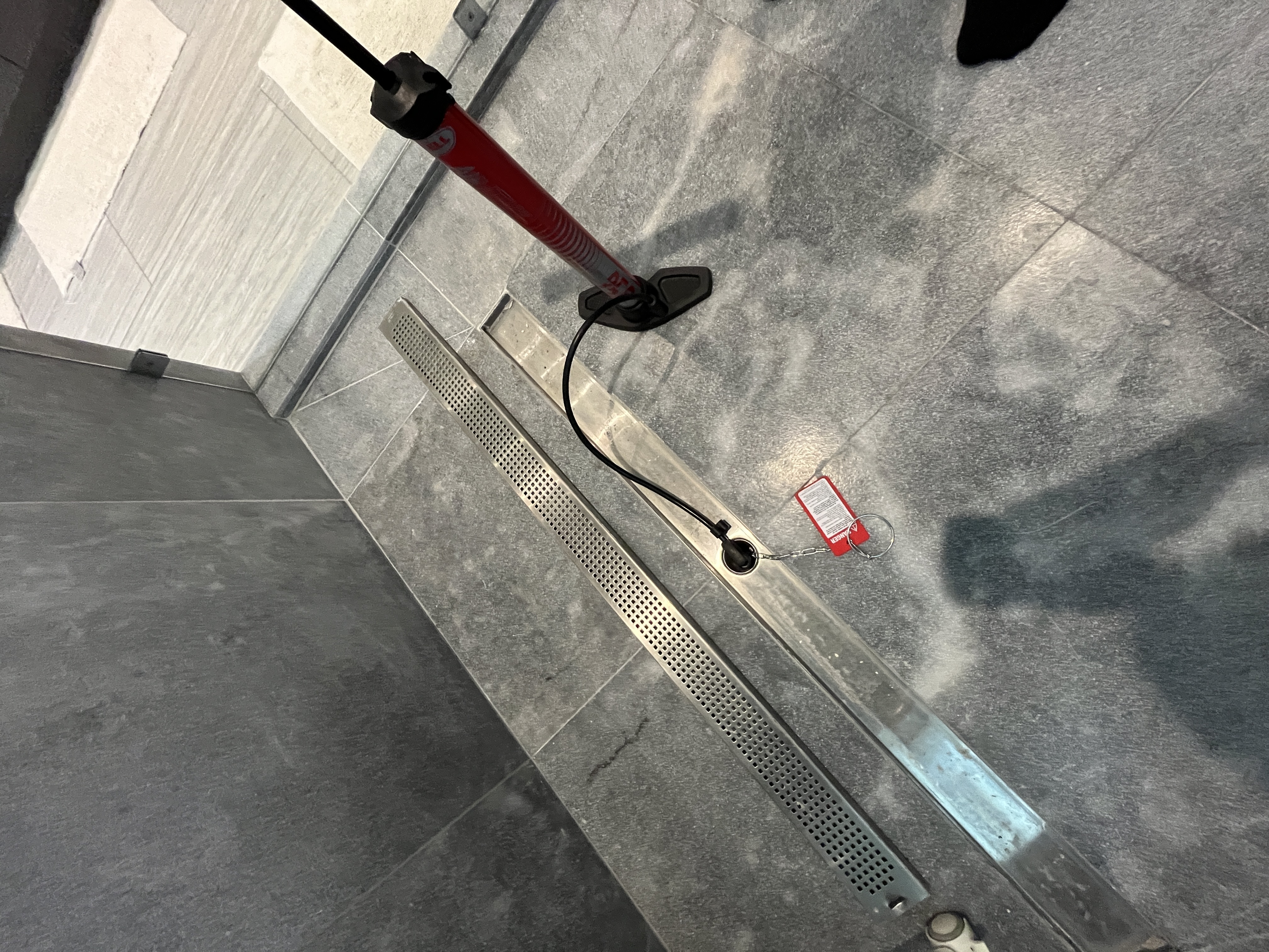 Professional performing shower pan leak test during water damage inspection in South Florida