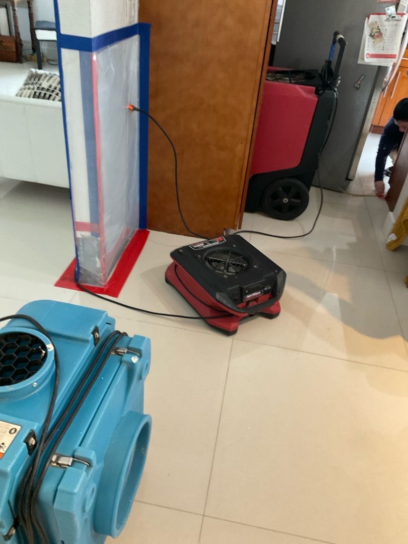 Water damage drying equipment with fans set up in kitchen area